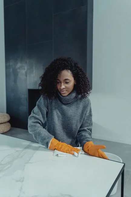 a-woman-is-cleaning-a-kitchen-sink-with-a-rag-sqomdoqb3ws